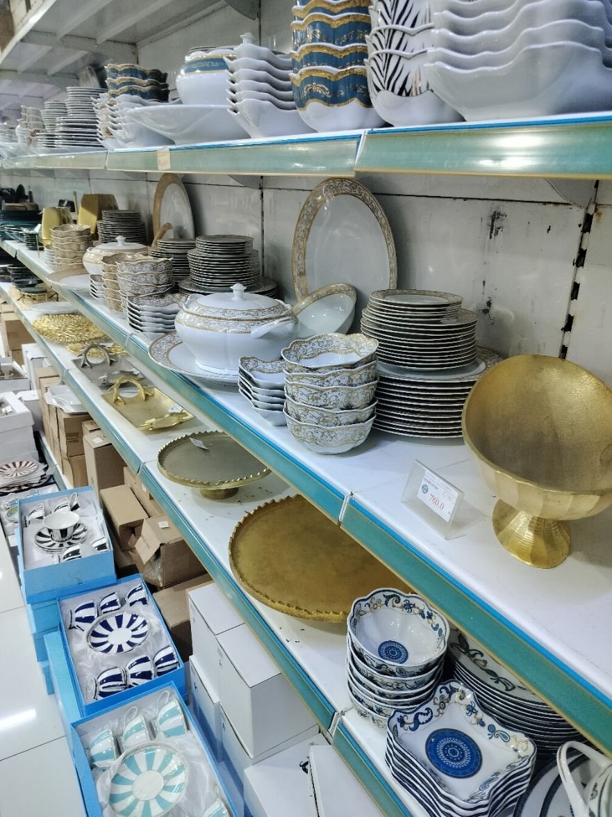 Un rayon de magasin vendant de la vaisselle et des articles de table, incluant des assiettes, des bols, des tasses, photo gratuite