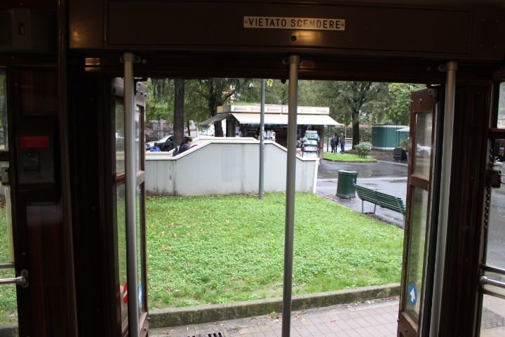 L'intérieur d'un tramway avec la porte ouverte donnant sur un espace extérieur, un jardin, photo gratuite