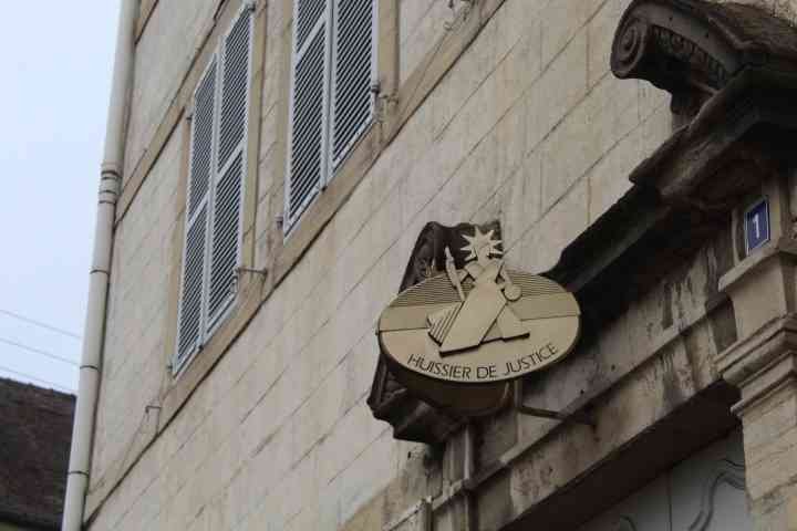 Plaque d'huissier de justice sur un bâtiment en pierre photo gratuite